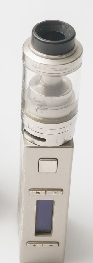 A brushed-steel box mod with a glass tank, on a white surface